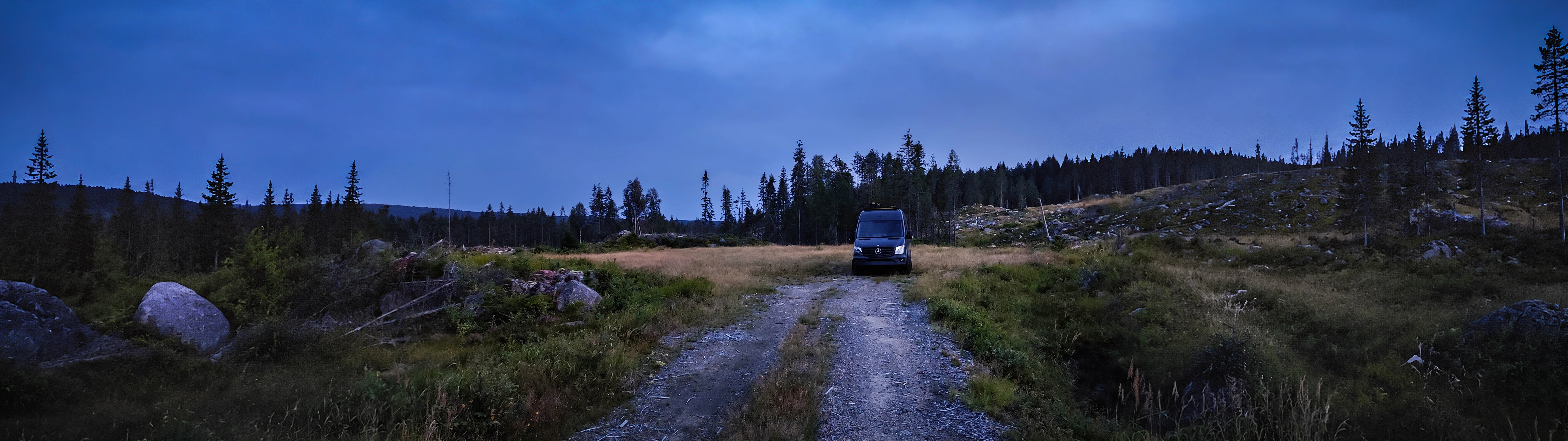 outarc campervan in a forest clearing at blue hour